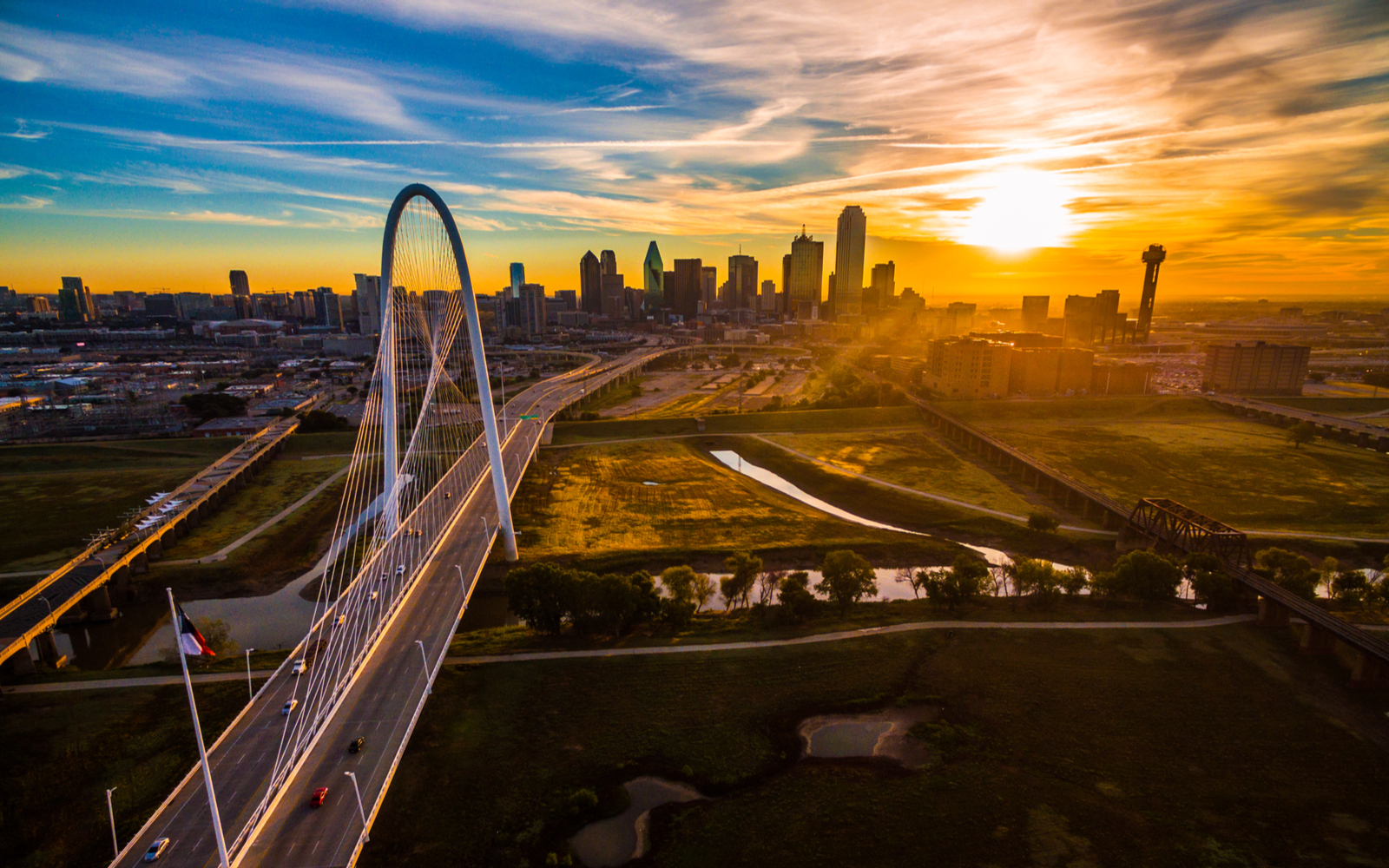 Best hotels in Dallas featured image showing a bridge and the skyline of downtown