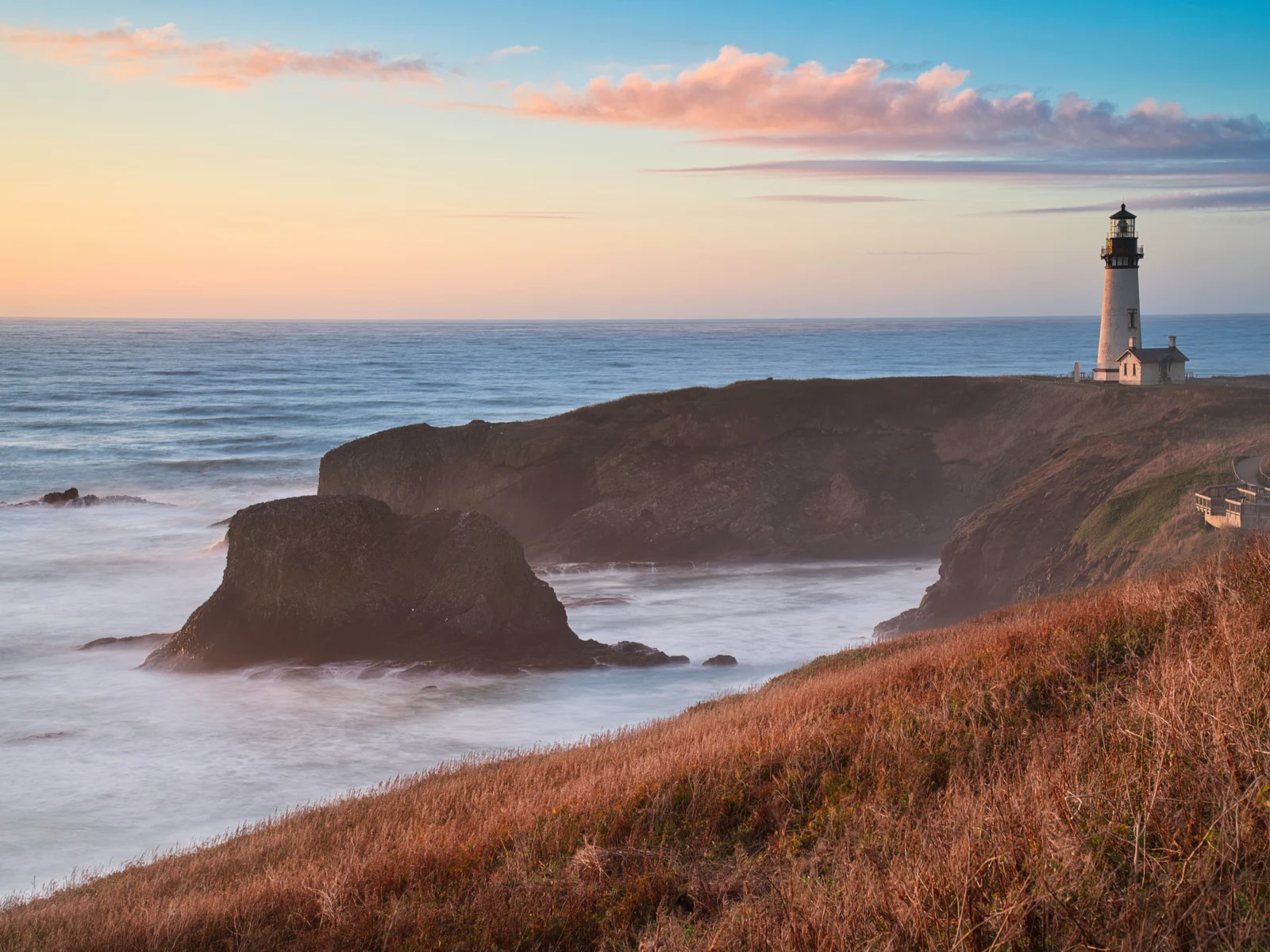 Yaquina Head Lighthouse at sunset for a piece on the best places to visit in Oregon