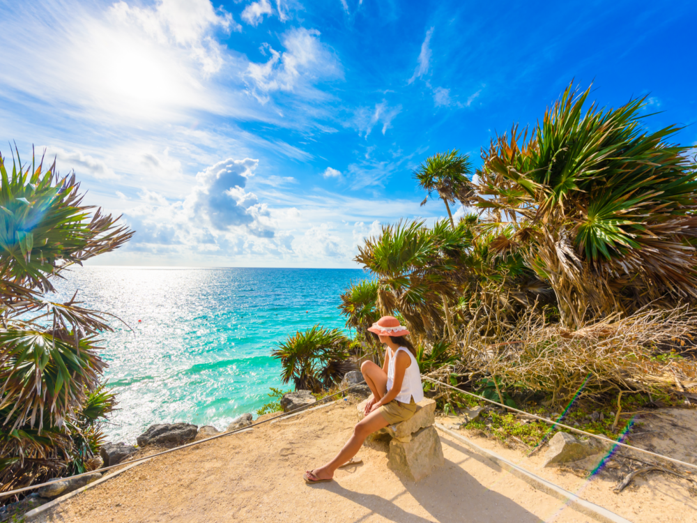 Woman seeing the ruins in Tulum, one of the things to do while staying at the best all-inclusive resorts in Cancun