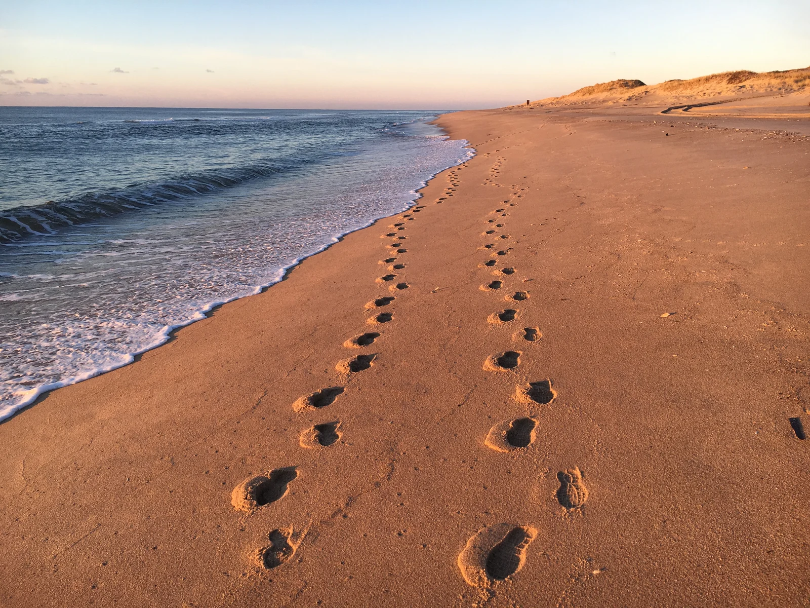 Footprints on a beach in Amagansett, one of our top picks for where to stay in the Hamptons