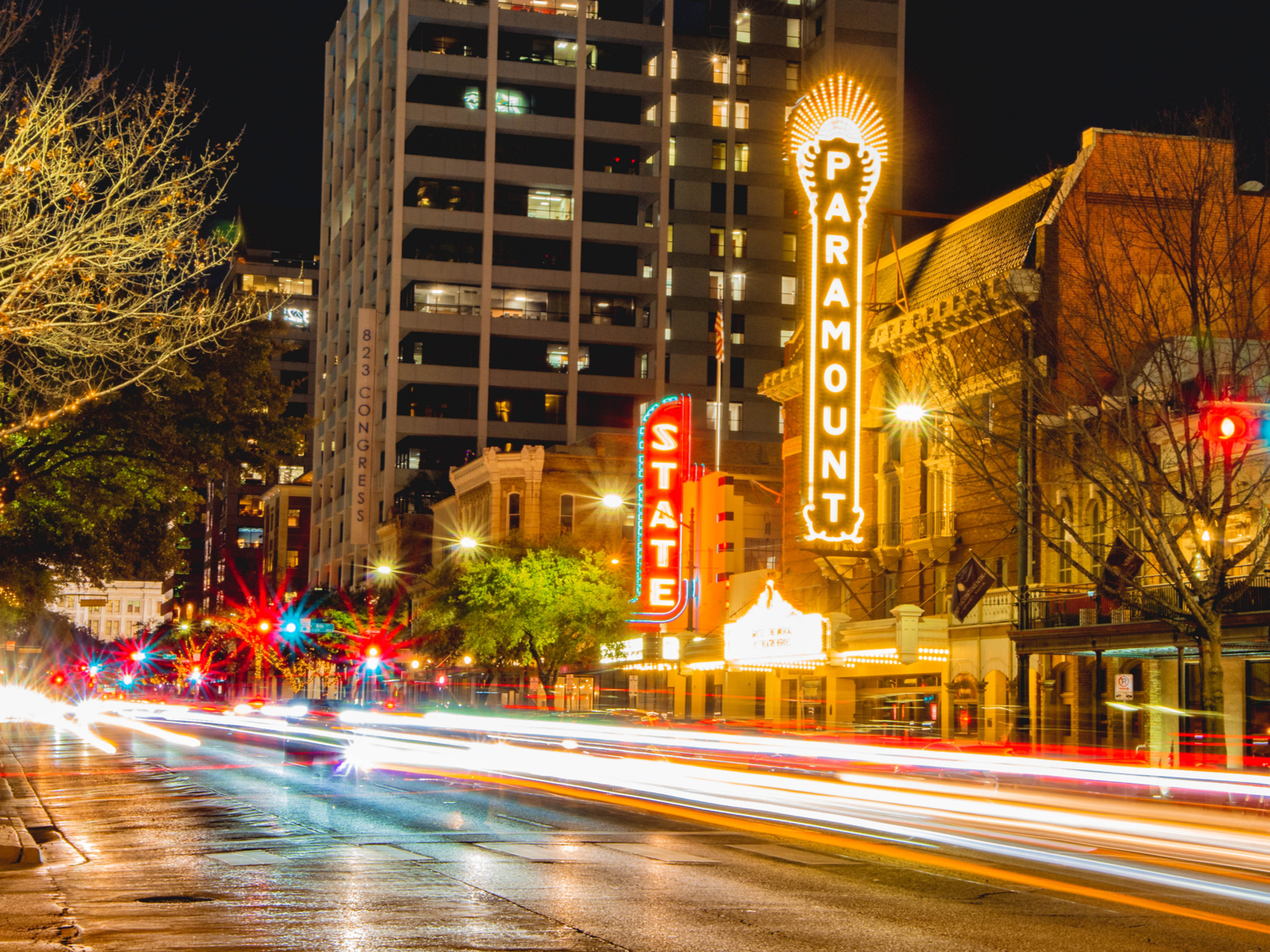 Long exposure of traffic on a downtown street pictured during the cheapest time to visit Austin
