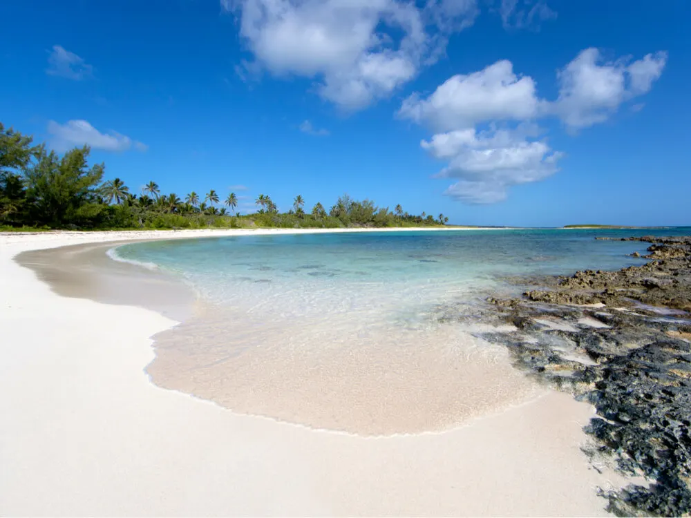 Eleuthera, one of our top picks when considering where to stay in the Bahamas, pictured from the rocks of a sandy beach