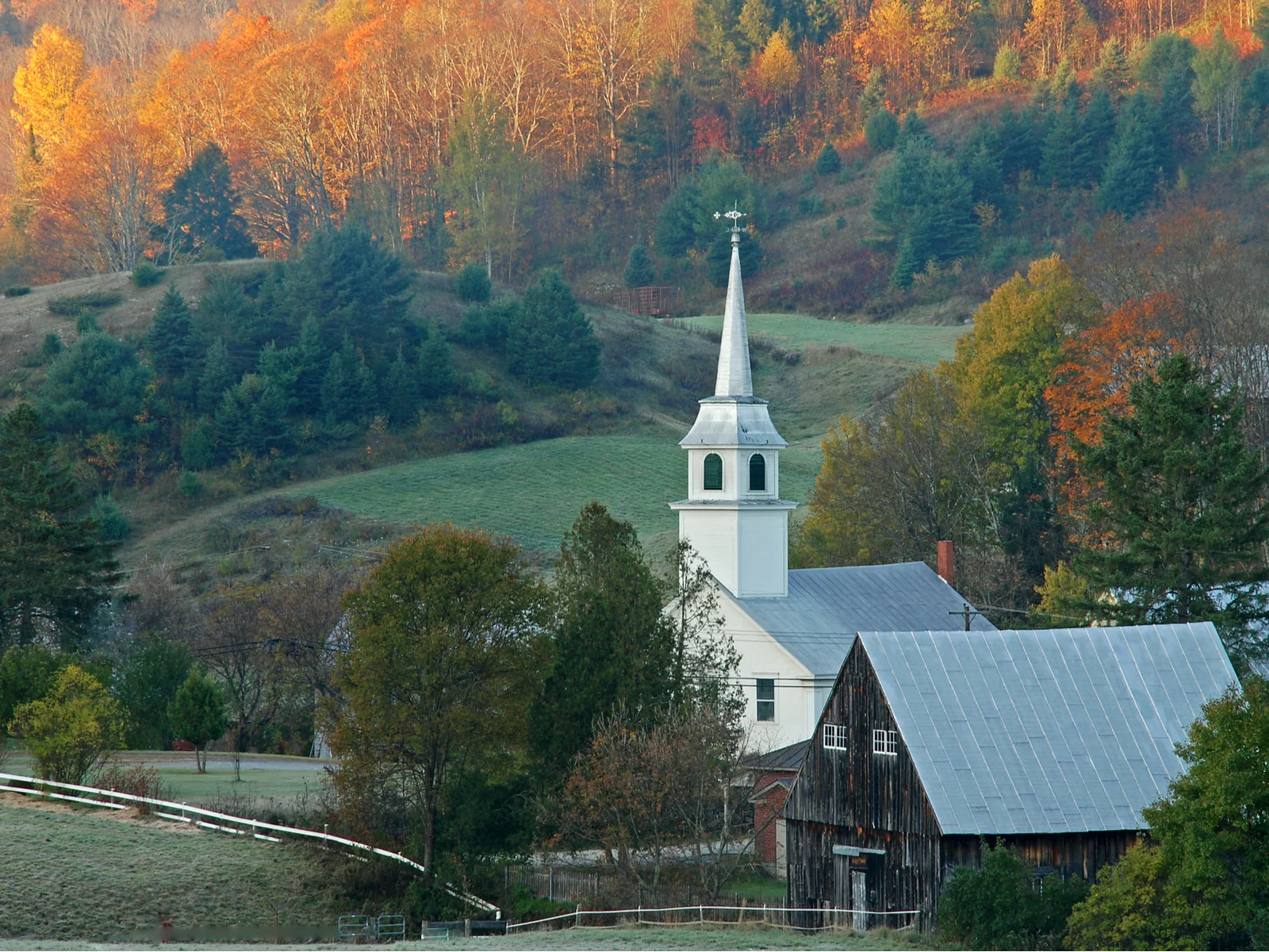 East Corinth, one of the best attractions in Vermont, and also the filming location of Beetlejuice, pictured at sunrise with sweeping hills in the background