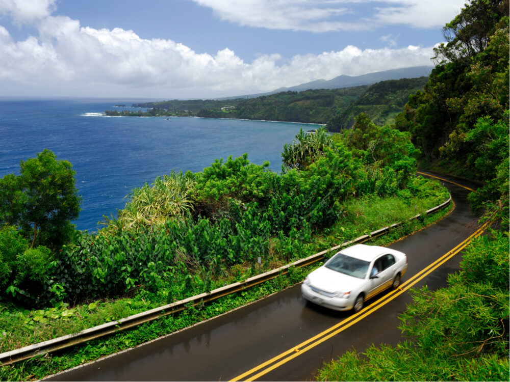 Car on the road to Hana, as pictured against the coast for a piece on the best things to do in Maui