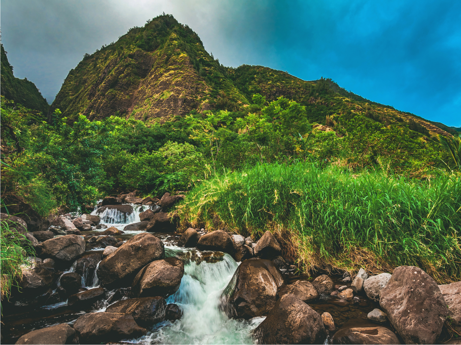 Iao Valley State Park with the waterfall running from the top of the hill
