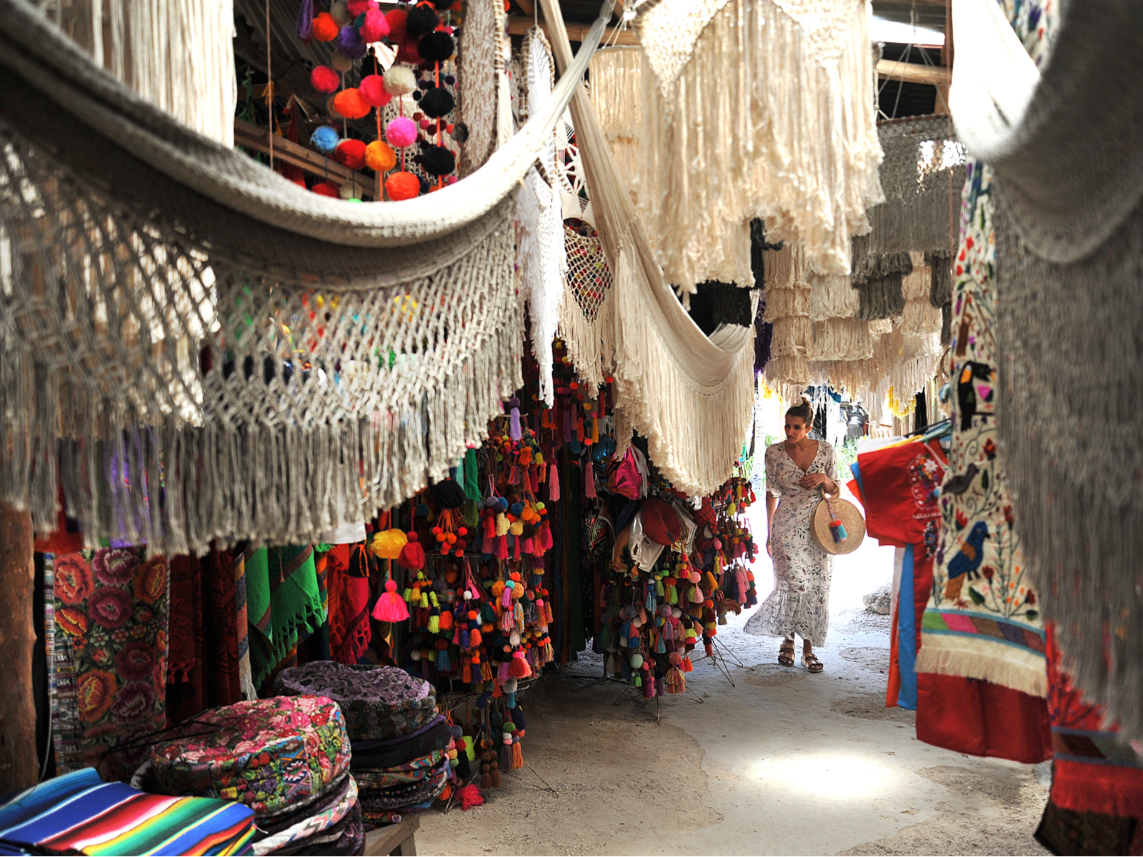 A photo of a woman walking through the market by one of the best areas in Tulum to stay