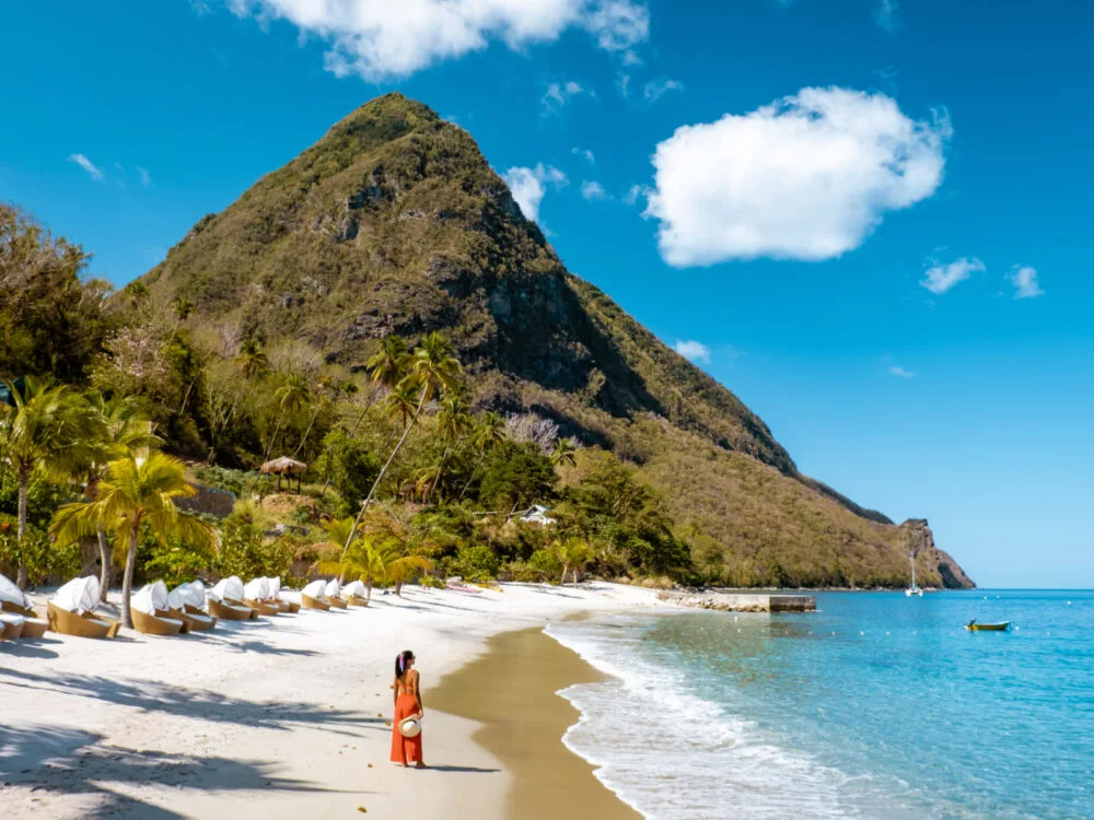 Woman in a red dress on a beach on one of the Caribbean's safest islands, St. Lucia