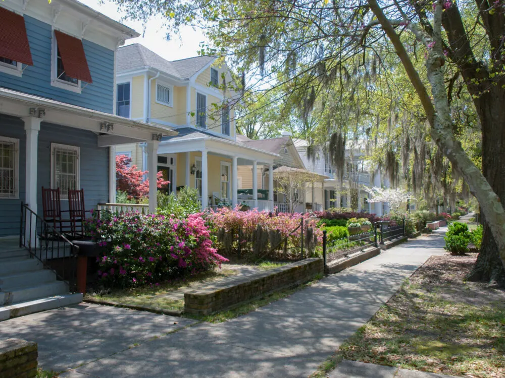 Street view of Wilmington, one of the best places to visit in North Carolina, on a walking path with trees drooping over the street