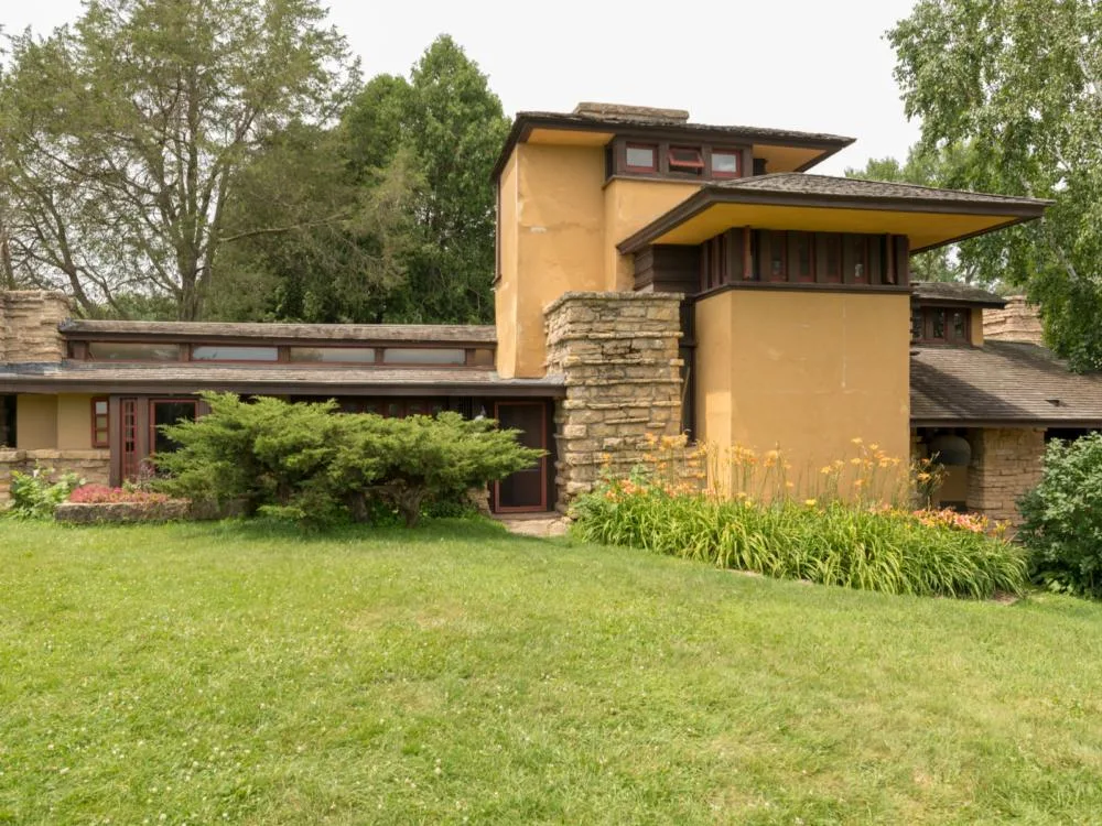 A view of Taliesin, a piece on the best Wisconsin tourist attractions, surrounded by a green landscape and was once a home of the famous architect Frank Lloyd Wright