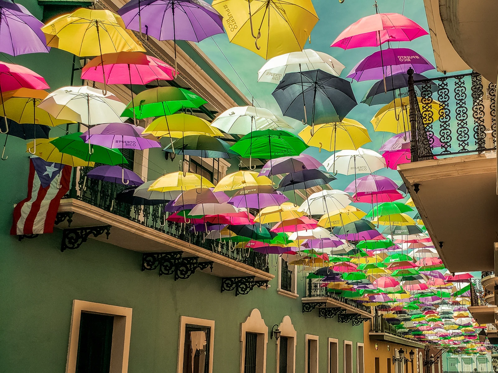 Image of a bunch of umbrellas on the ceiling of a market in San Juan for a piece titled the Best Things to Do in Puerto Rico