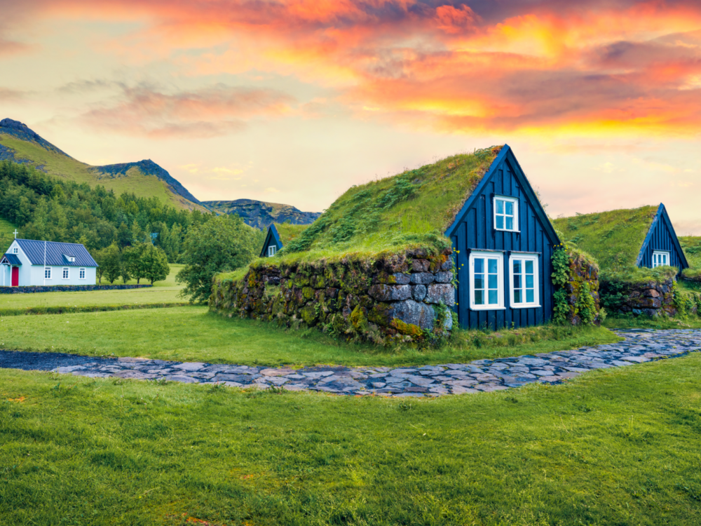 Image of a turf-covered house for a piece on the best hotels in Iceland