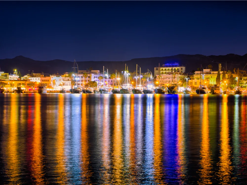 Colorful nightlight at a post in Kos Island, a piece on the best islands in Greece to visit, where boats are docked