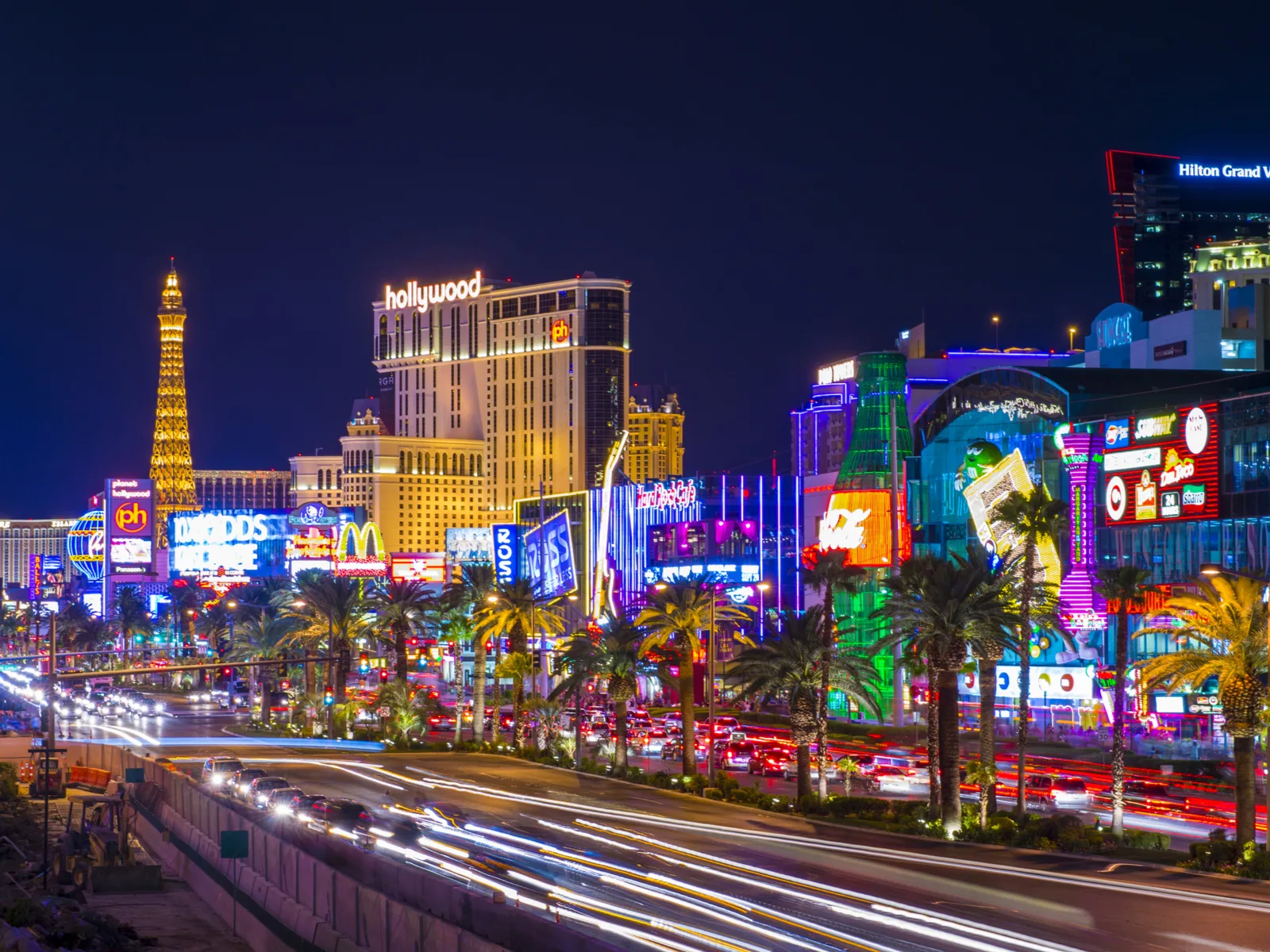 The strip, one of the best things to do in Las Vegas, viewed at night with lights flashing all over