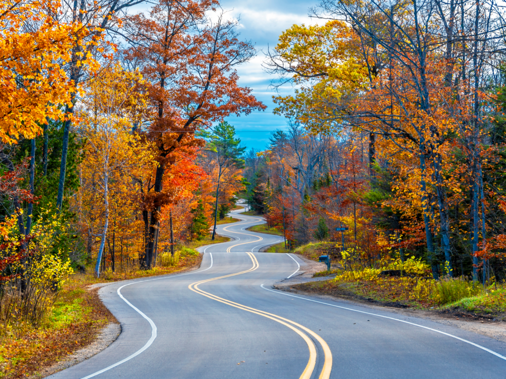 Empty winding road at Autumn in Door County as one of the best Wisconsin tourist attractions