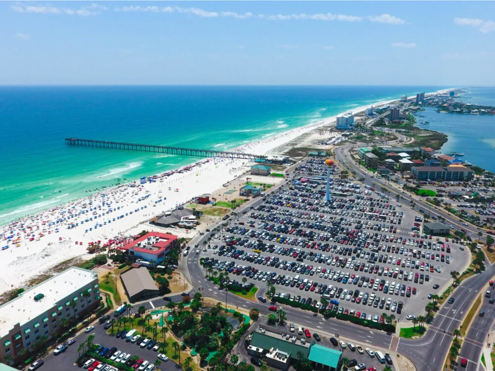 Beautiful day in one of the best places to visit in Florida, Pensacola Beach, with blue sky and deep blue water