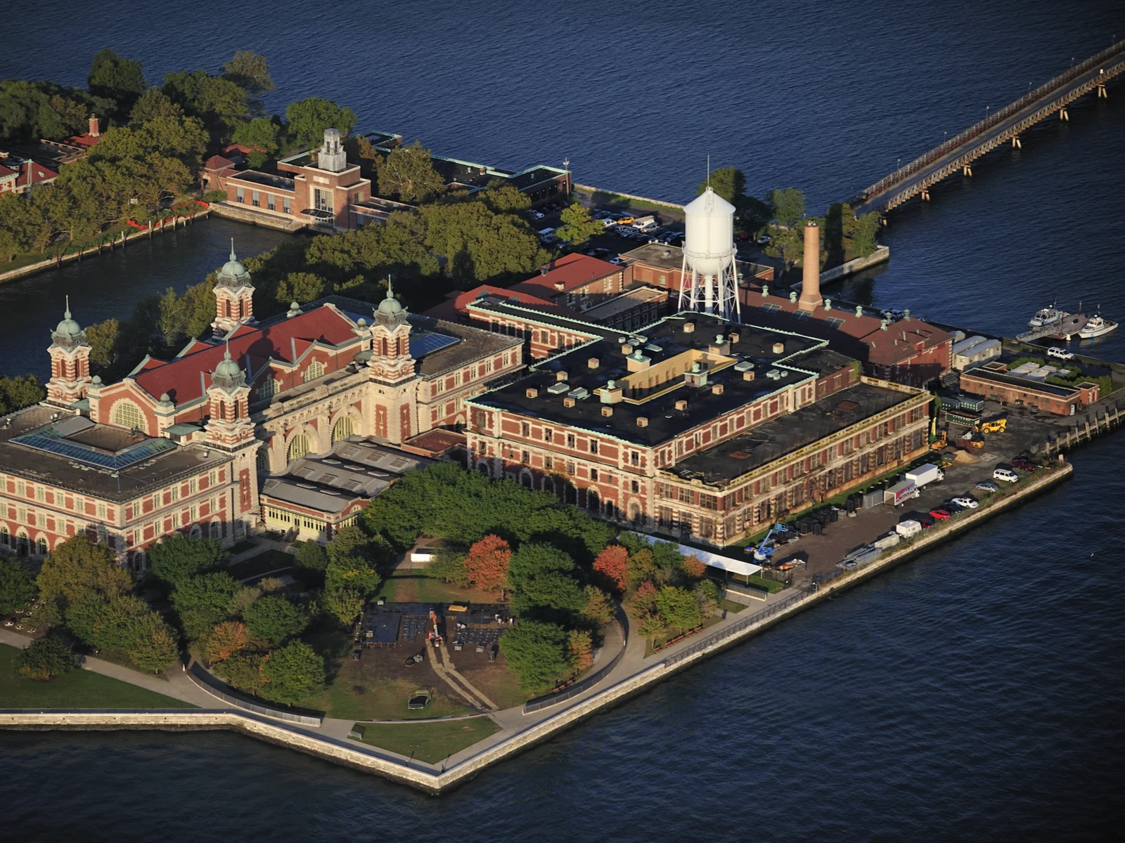 Aerial view of the historic buildings at Ellis Island surrounded by a calm sea, visiting via ferry is one of the best things to do in New Jersey