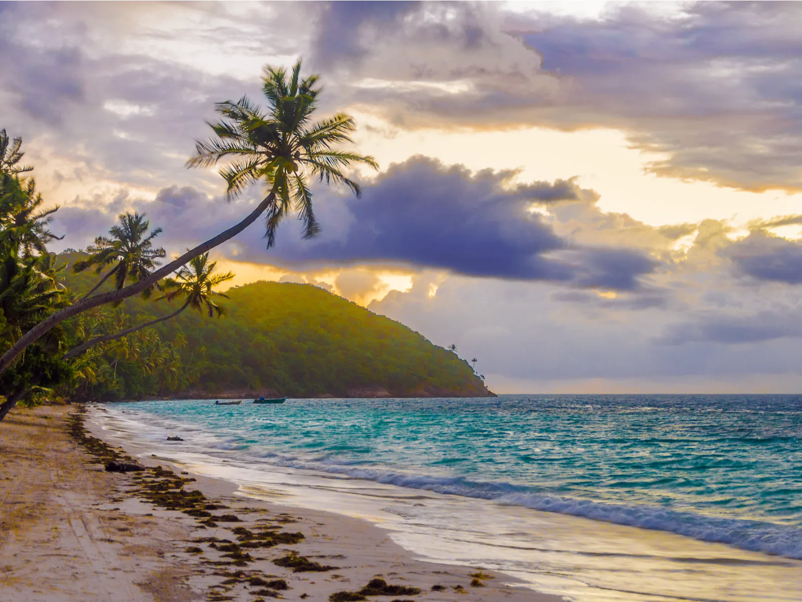 To illustrate the best time to visit Colombia, a sunset over the San Andres beach is pictured