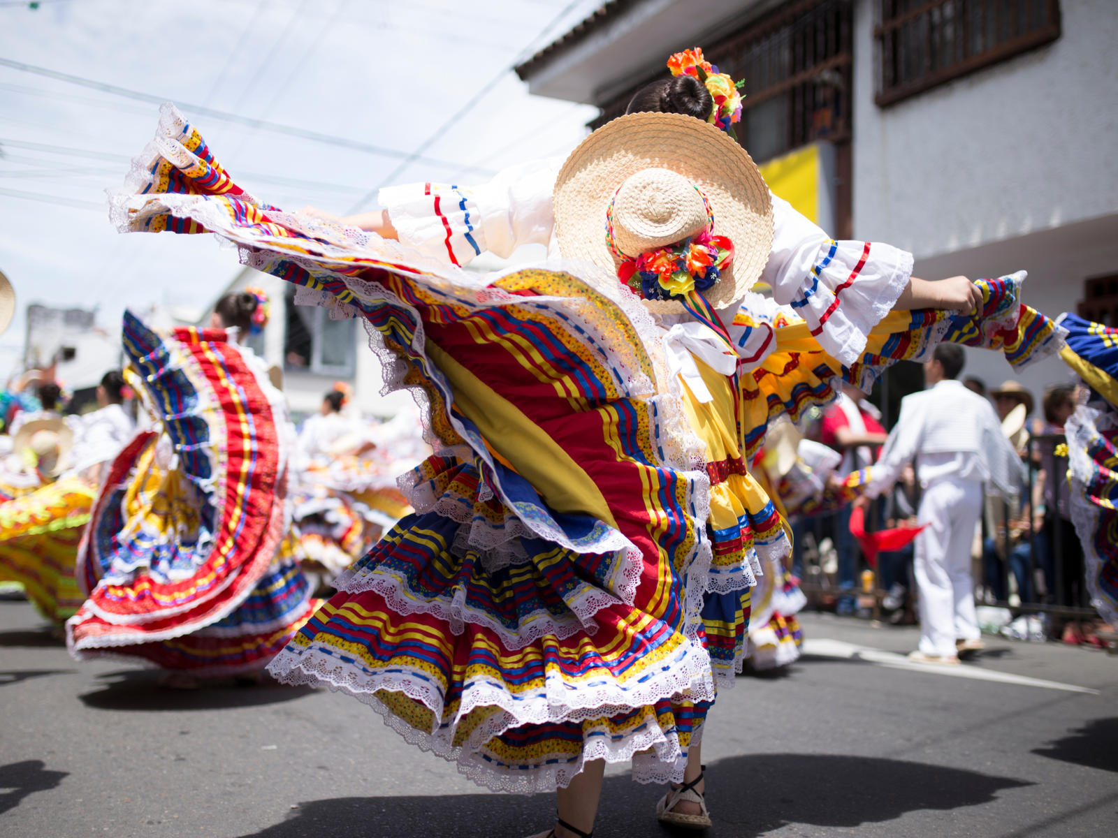 Woman dancing in the streets of Ibague during the best time to visit Colombia