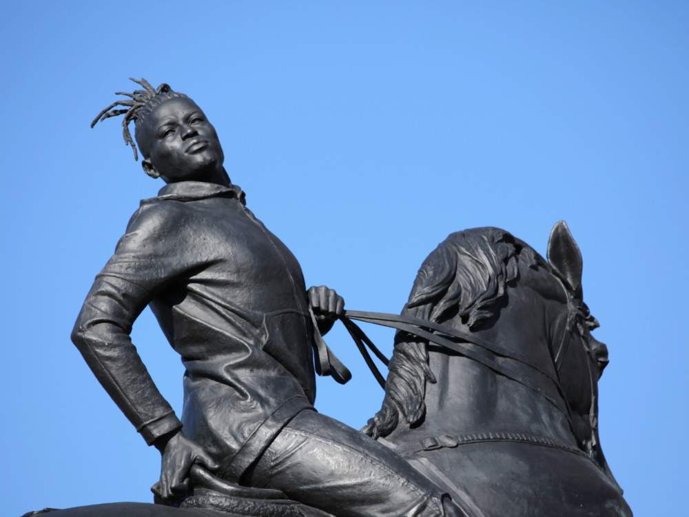 Visiting the statue of a black man on horse back titled Rumors of War by Kehinde Wiley is one of one of the things to do in Virginia, erected in front of Museum of Fine Arts