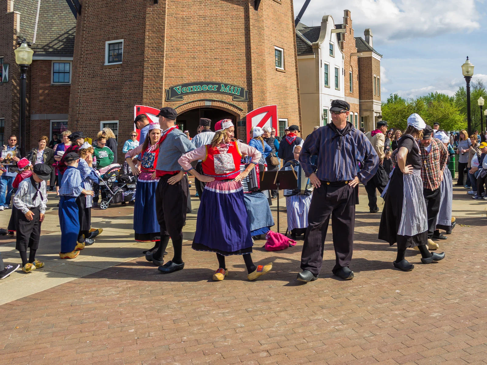 Locals celebrating the Tulip Time Festival at Pella's dutch community, a pick for what to see in Iowa, where they wear vibrant national dutch costume to honor the citizens who immigrated from the Netherlands