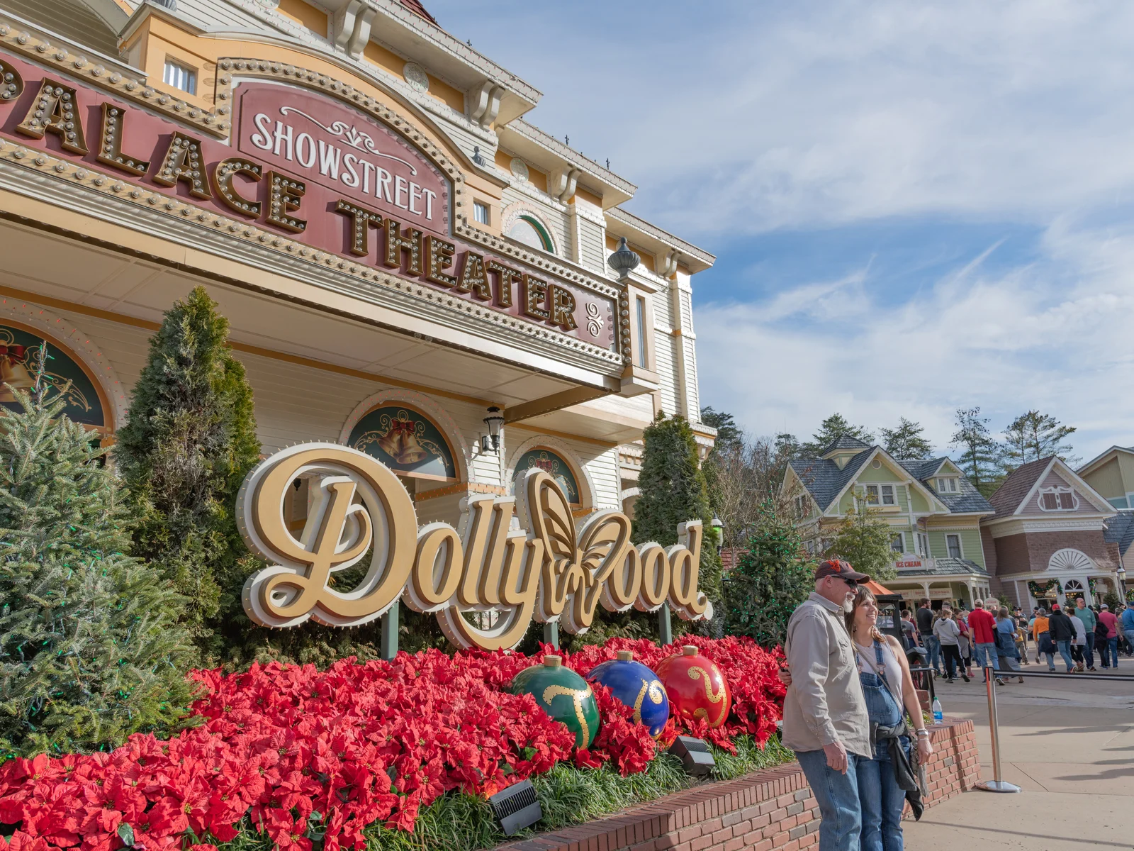 A couple posing for a picture and a crowd in Dollywood, a famous attraction and one of the best things to do in Tennessee