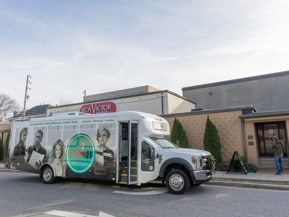 A bus, painted with pictures of recording artists, parked in front of the famous RCA Studio B which is one of the best things to do in Tennessee