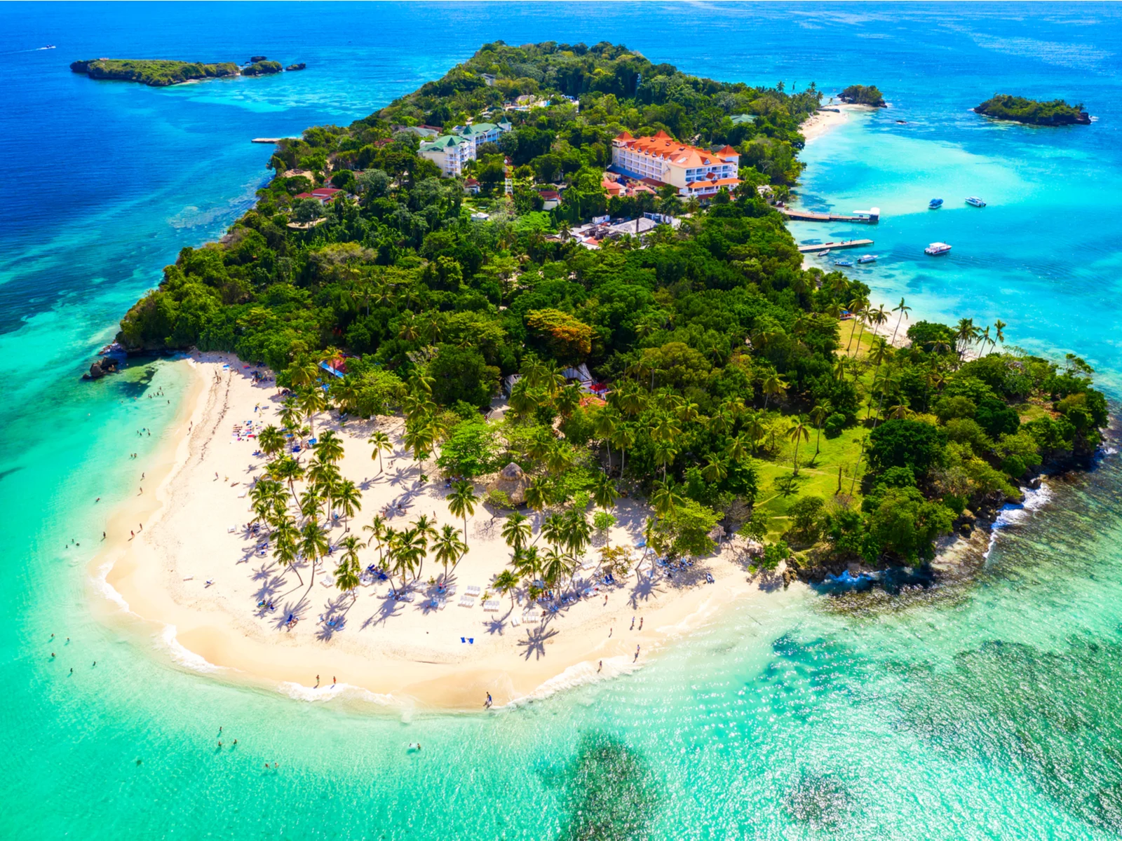Aerial view of the small island of Cayo Levantado in Samaná, one of the best beaches in the Dominican Republic, with some tourist enjoying the white sand beach and a couple of vacation hotels at the center of its small forest