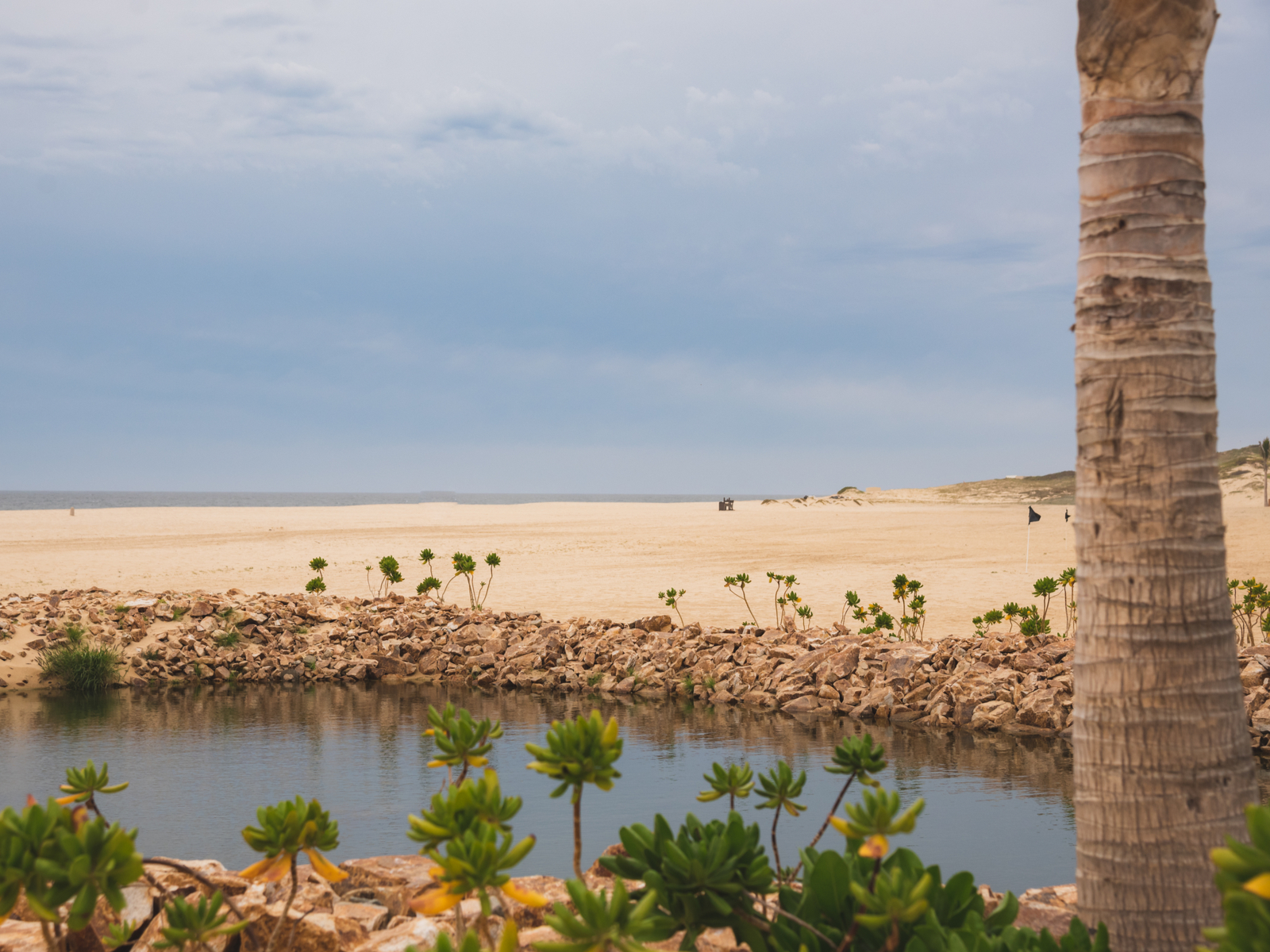Beach pictured during the worst time to visit Cabo with rain on the horizon