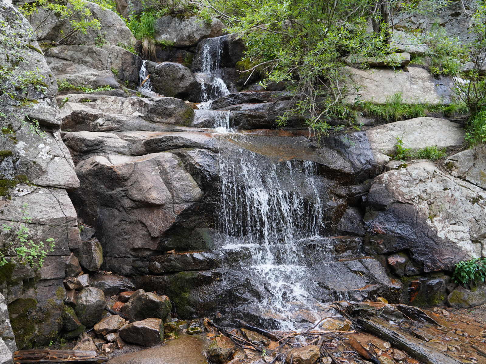 A small flowing stream on huge rocks in one of the best hikes nears Denver, Maxwell Falls Loop Trail