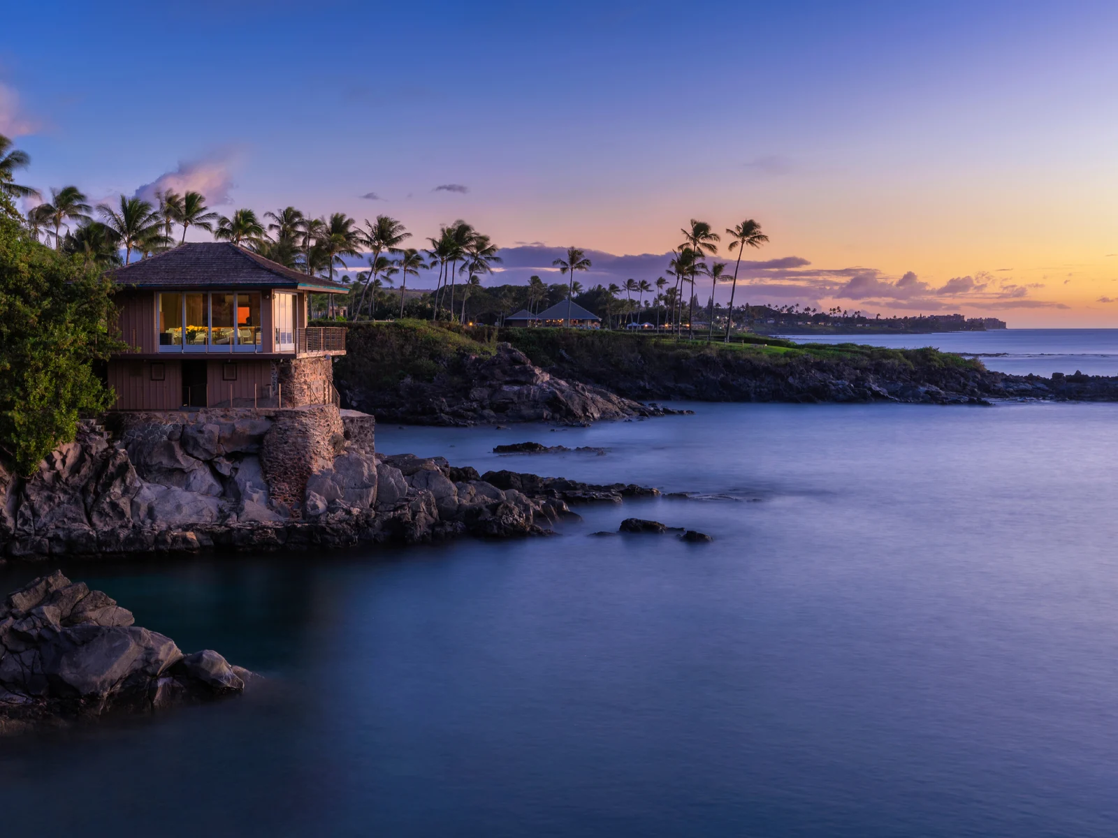 Cliff house on Maui at dusk for a piece on the best Airbnbs in Hawaii