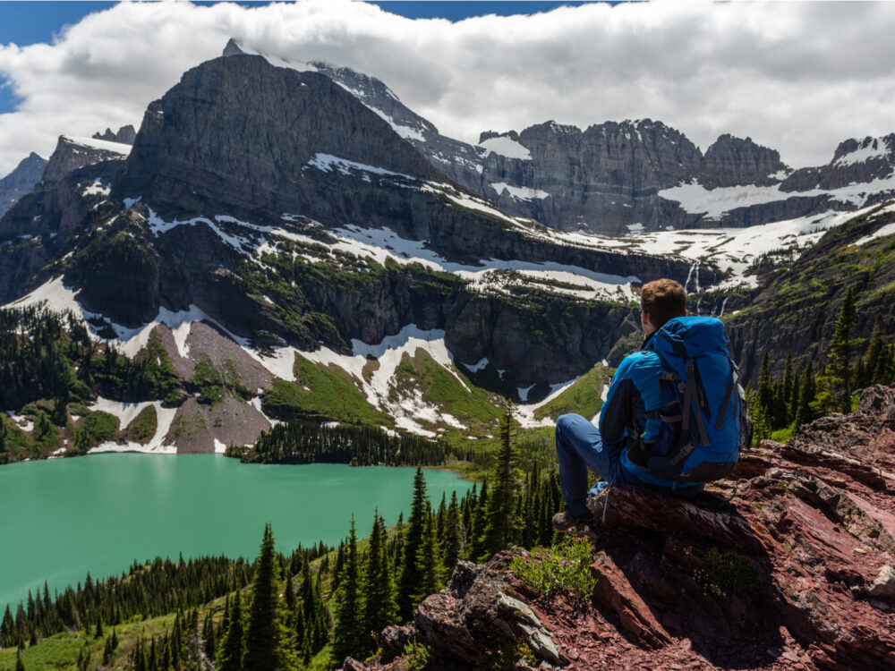 Hiker viewing Grinnell Lake during the best time to visit Glacier National Park