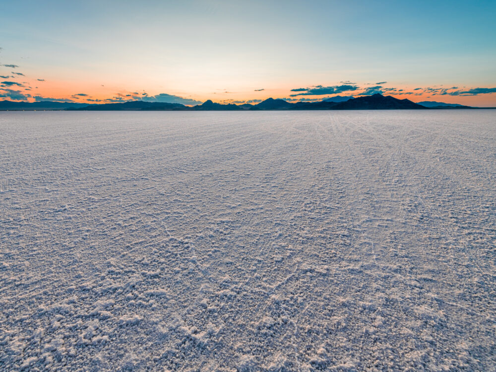 Sunrise image of one of the best places to visit in Utah, the Bonneville Salt Flats