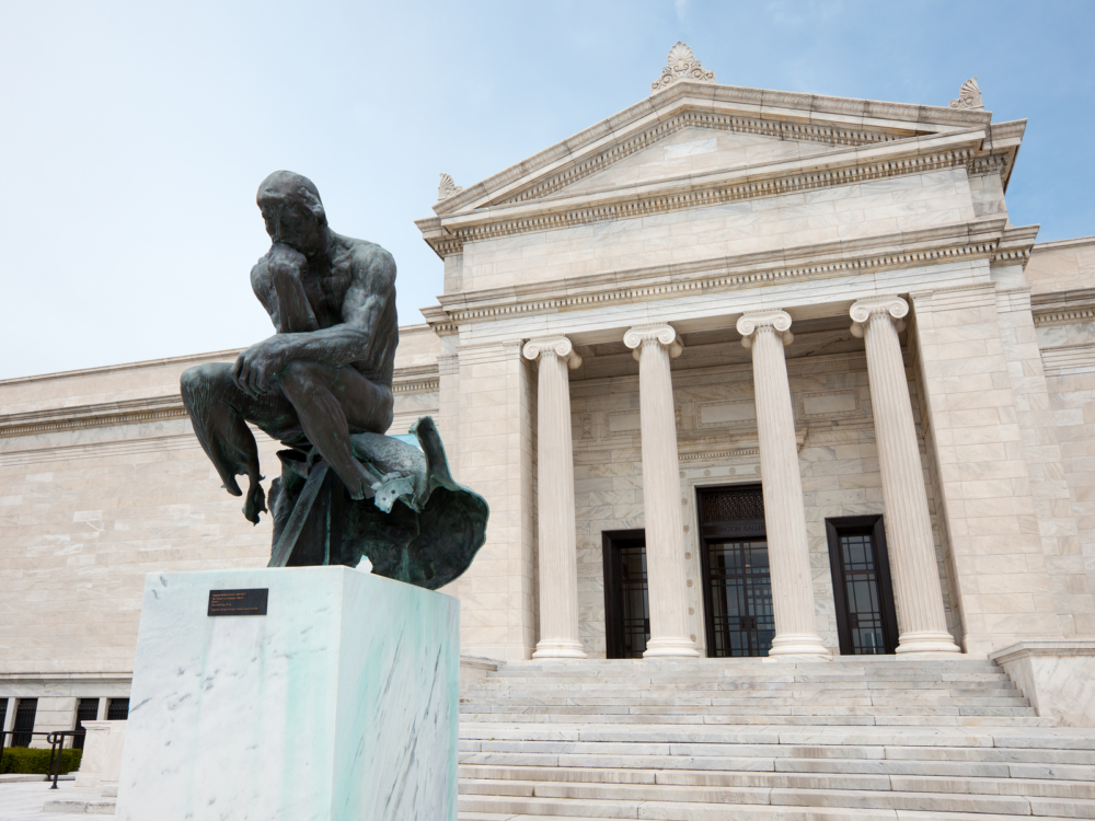 One of the best things to do in Ohio, looking at the famous Auguste Rodin Statue sitting in front of Cleveland Museum of Art with four gigantic columns