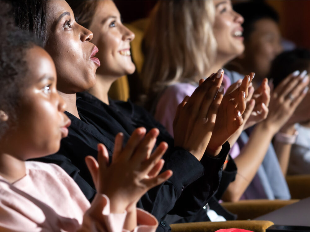 Pictured theater audiences clapping after an outstanding performance at the Municipal theater association for a piece on the best things to do in St. Louis