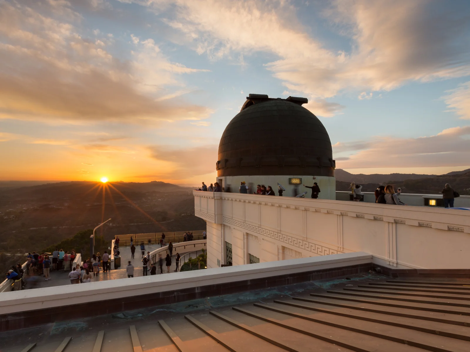 Griffith Observatory, one of the top things to do in Los Angeles, pictured at dusk with a close up of the telescope structure