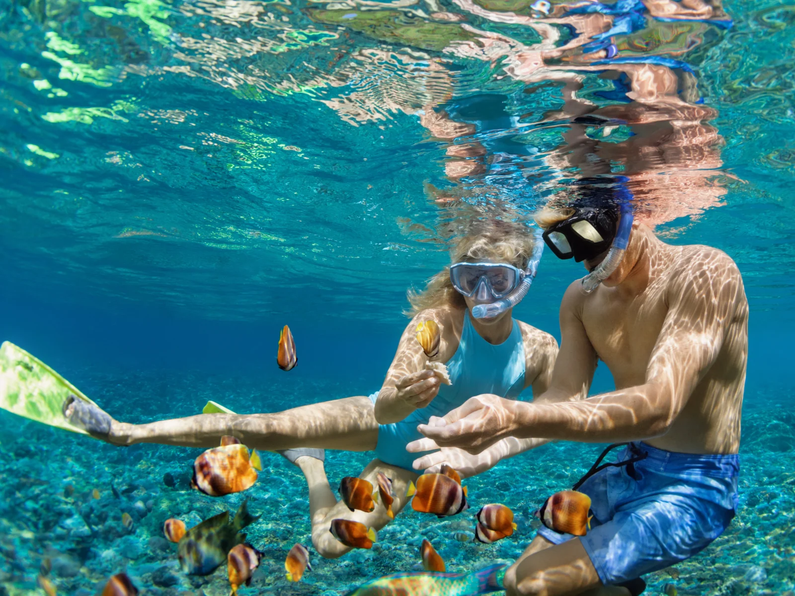 Couple snorkeling for a piece on the best Airbnbs in Oahu
