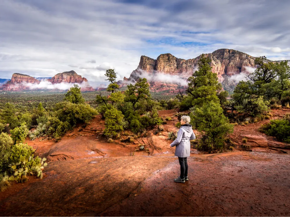 Image of a woman looking at the red rocks of Sedona for a piece on the best time to visit Arizona
