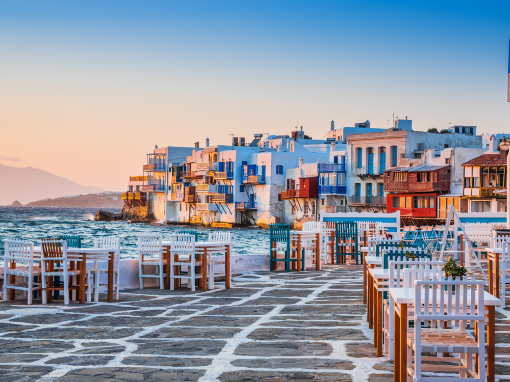 Empty tables and chairs at Little Venice waterfront on early morning in Mykonos, one of the best places to visit in Greece
