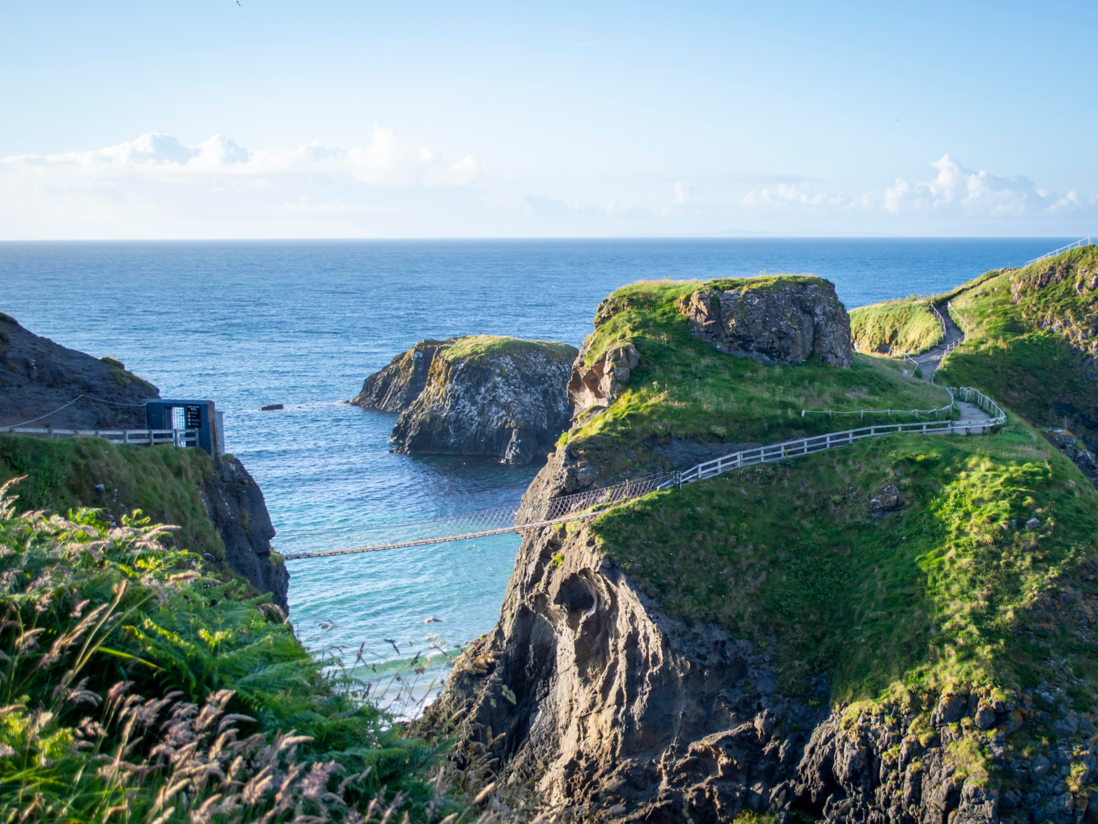 The famous Carrick-a-Rede Rope Bridge and a winding coastal trail at the calm Causeway Coast is one of the best hikes in Ireland