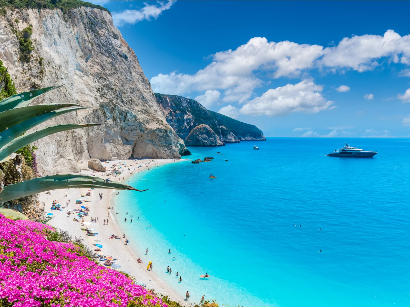 Porto Katsiki, one of the best beaches in Greece, as seen from a hilltop with flowers on the left side of the photo