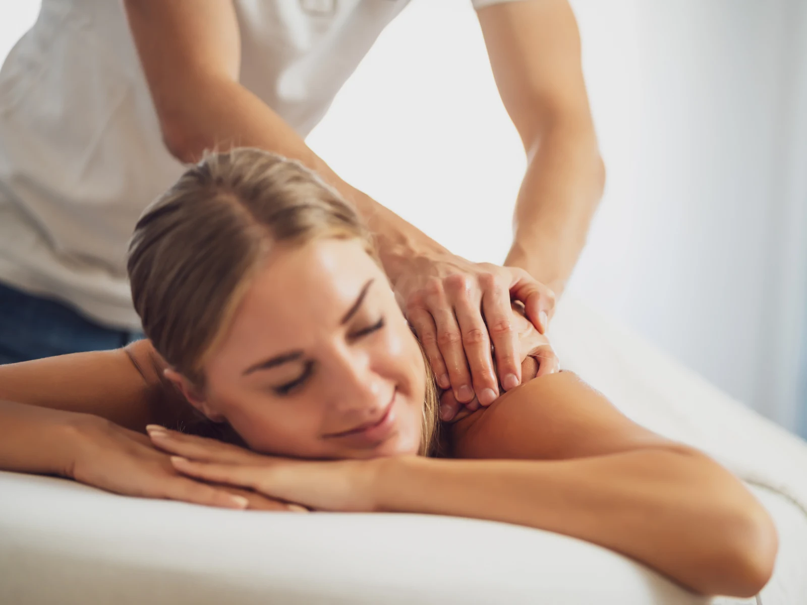 Woman getting a massage at a spa, one of the best things to do in Phoenix