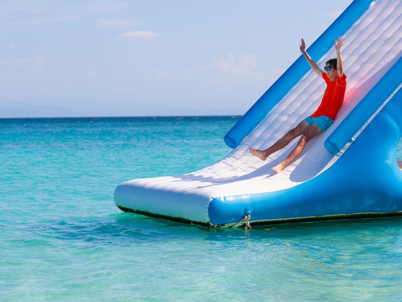 Kid sliding down a slide at Splash Island Waterpark St. Lucia