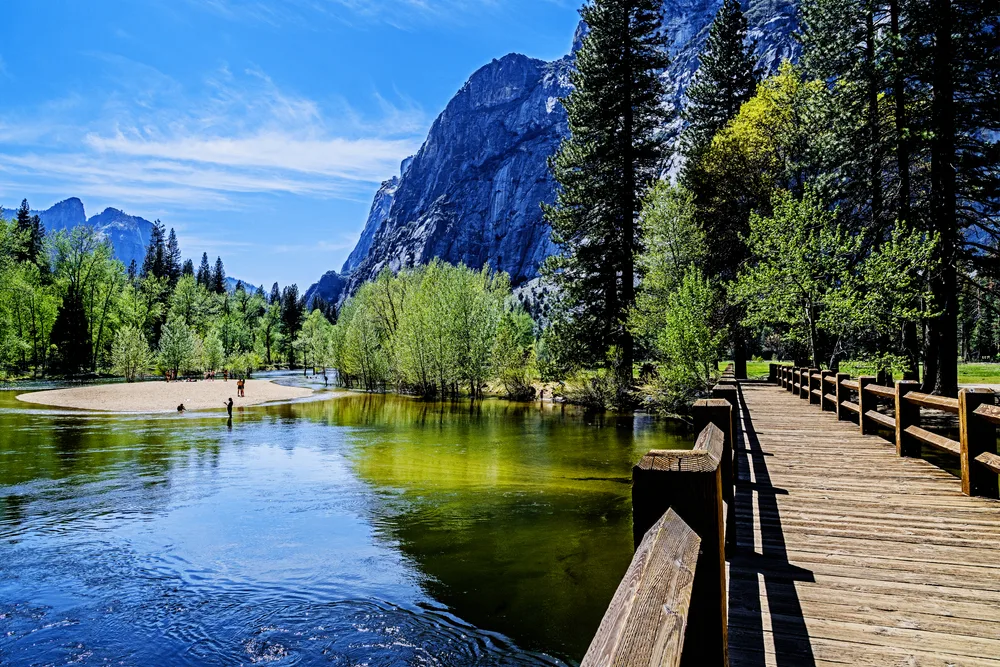 Amazing view of the Swinging Bridge pictured with a neat island on the left for a guide titled Best Time to Visit Yosemite