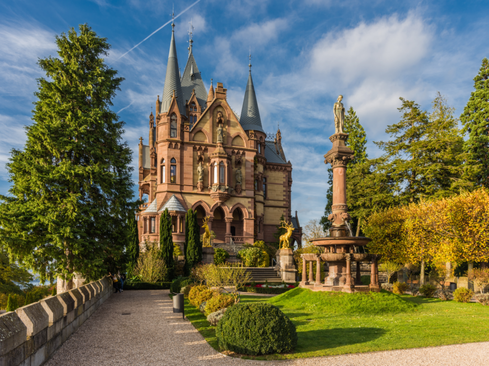 The grand Drachenburg Castle in Königswinter, considered as one of the best castles in Germany, stationed two golden deer statue at the entrance and a woman statue atop a fountain 