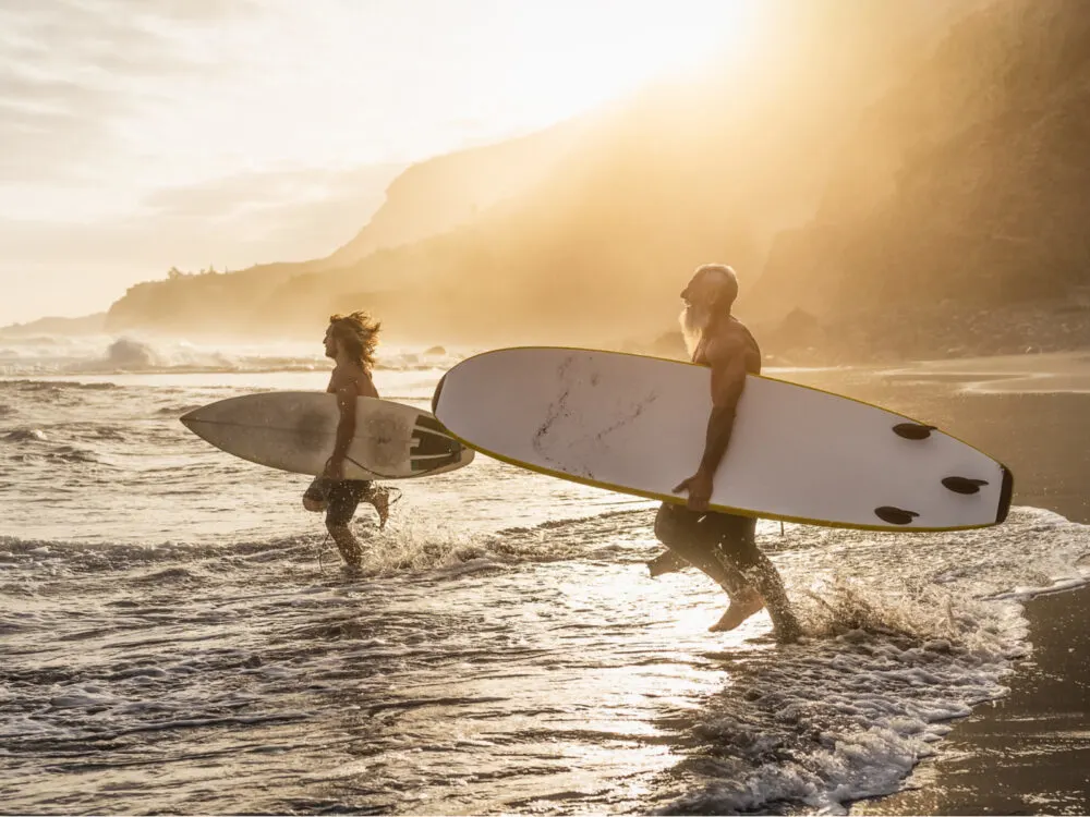People surfing on the ocean in Maui for a piece on the best things to do on the island