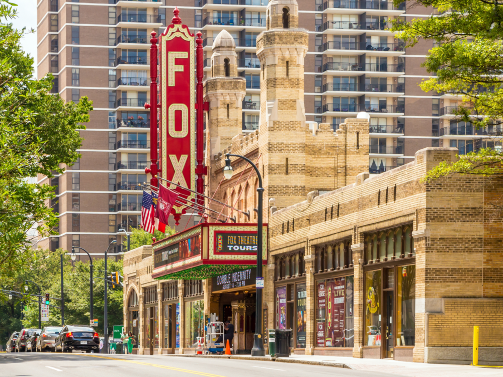 Huge deep red signage of Fox Theater, one of the best tourist attractions in Georgia, attached on its iconic old looking structure