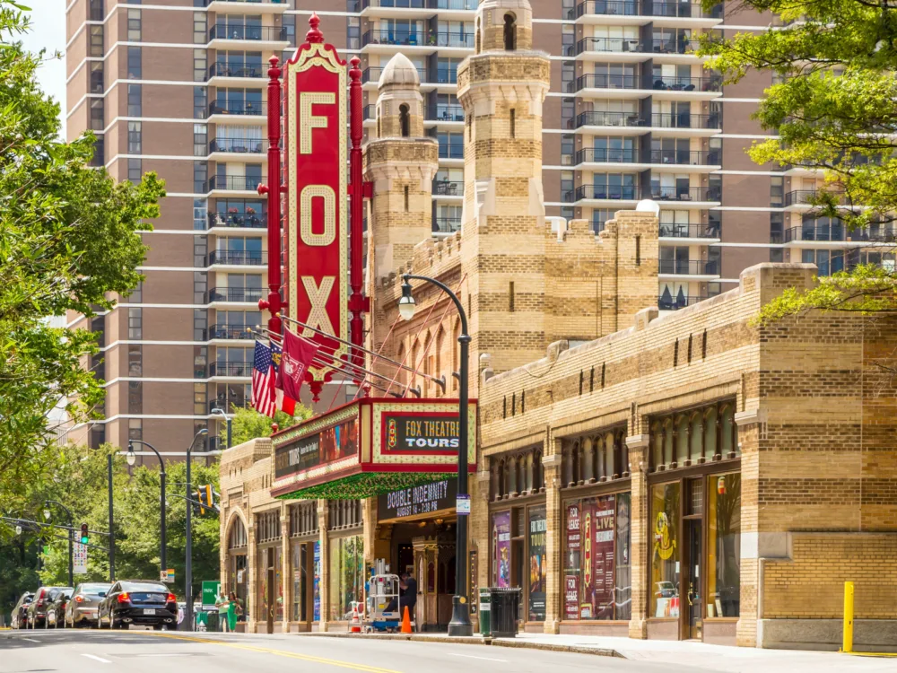 Huge deep red signage of Fox Theater, one of the best tourist attractions in Georgia, attached on its iconic old looking structure