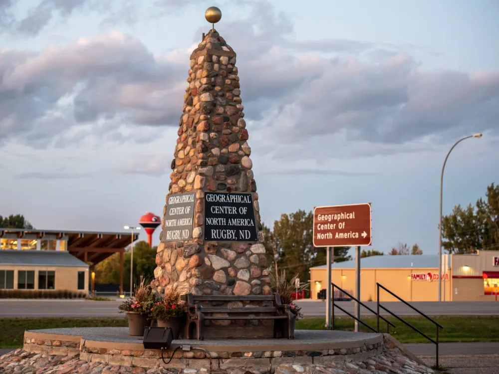 A bench on one side of the famous stone obelisk at Geographic Center of the United States, one of the best things to see in Kansas