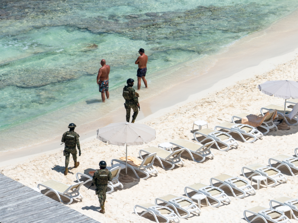 Overhead shot of armored guards walking one of the best beaches in Cancun