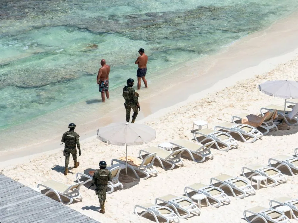 Overhead shot of armored guards walking one of the best beaches in Cancun